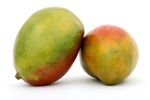 Two ripe mangos leaning against one another